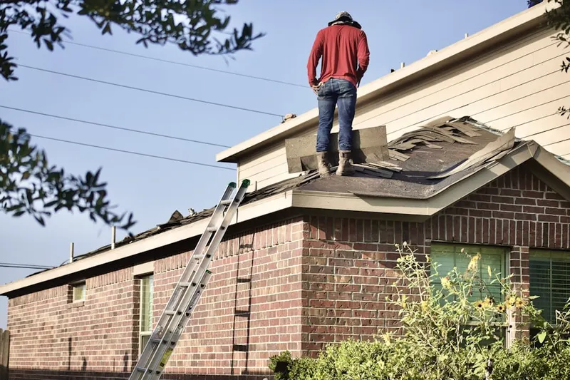 Professional roofer working on a residential roof in Parkway - Wheelers Farm Road